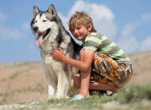 Boy hugging a fluffy dog