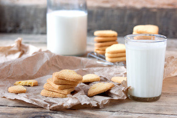 Some cookies and a glass of milk on the wooden table