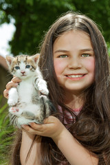 Happy little girl  with a little cat