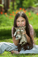 Happy little girl  with a little cat