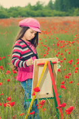 Vintage little girl on the poppy meadow