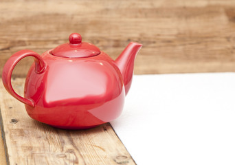 teapot on a wooden table and wood background, with space for tex