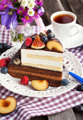 Piece of chocolate cake with cream and fresh fruit