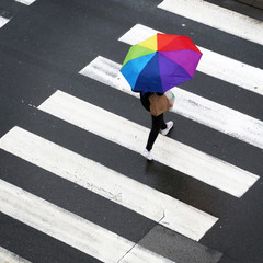 Rainy day, Woman crossing the zebra with umbrella