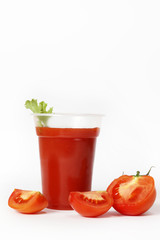 Tomato juice in glass on white background