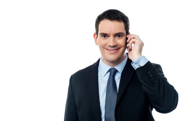 Smiling executive talking via mobile phone