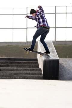 boy doing skateboard trick in skate park