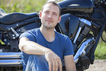 Fototapeta na wymiar Young man on a motorcycle on a sunny day