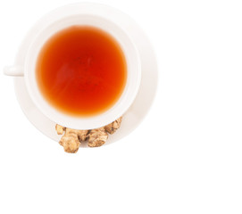 Ginger root and a cup of tea over white background