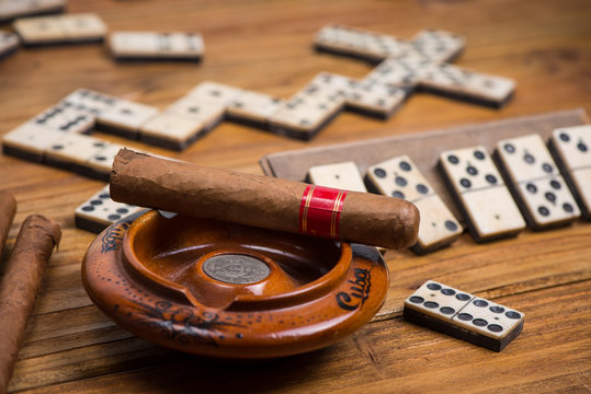 Cuban cigar on table with domino game