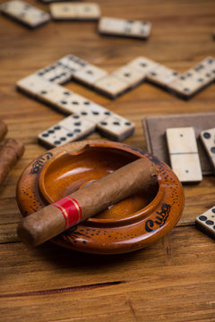 Cuban cigar on table with domino game