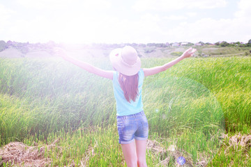 Portrait of beautiful young woman in field