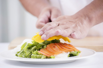 Chef's hands cutting yellow bell pepper