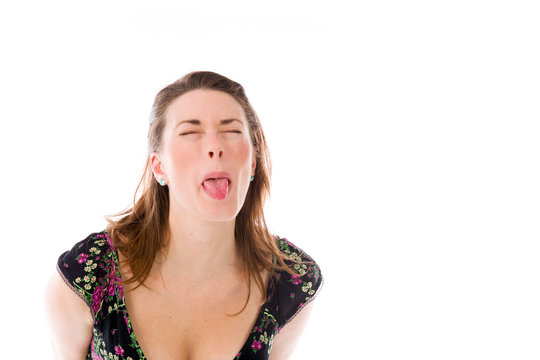 model isolated on plain background face sticking tongue out