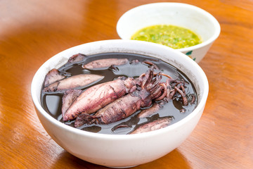 black squid boiled with seafood sauces