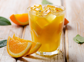 Orange juice  with ice on  a wooden background