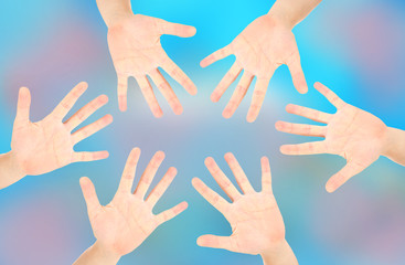 People's hands on bright background