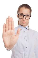 Serious young woman showing stop gesture isolated