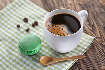 Cup of coffee and french macaron.