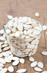 pumpkin seeds on wooden surface