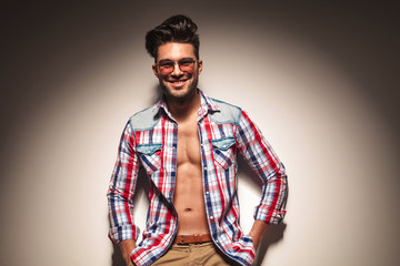 sexy young fashion man leaning on a wall