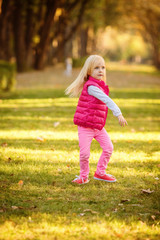 Beautiful girl blowing soap bubbles in the park