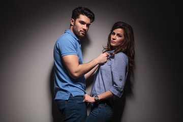 fashion man pulling his girlfriend towards him