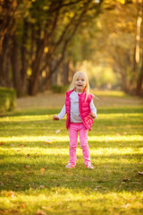 Beautiful girl blowing soap bubbles in the park