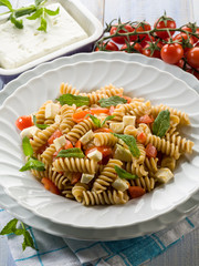 pasta with feta cheese fresh tomatoes and mint leaf