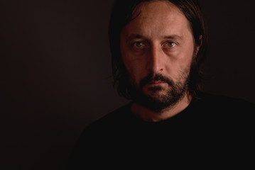 Man with beard, low key portrait