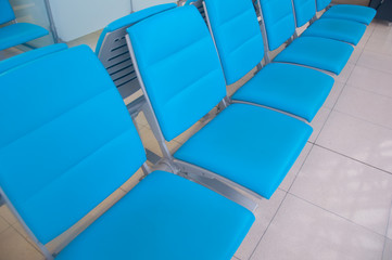 row of blue chair at airport