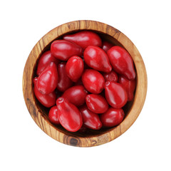ripe cornel berries in wood bowl