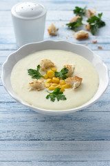 Vegetables cream soup with corn, croutons and parsley