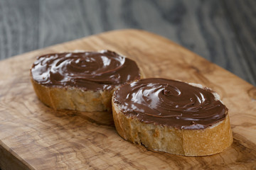 two baguette slices with chocolate hazelnut spread