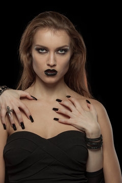 Gothic woman with hands of vampire on her body. Halloween