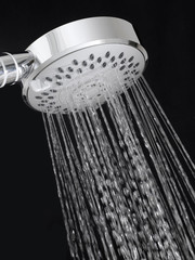 Silver shower head on black