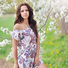 Fototapeta premium Young woman in the park in summer