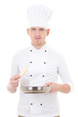 young man chef in uniform holding frying pan isolated on white