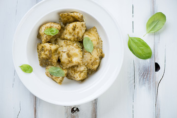 Above view of italian ravioli with pesto sauce, horizontal shot