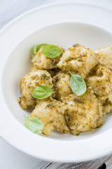 Close-up of ravioli with basil pesto, vertical shot