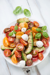 Salad with grilled avocado, tomatoes and mozzarella, close-up