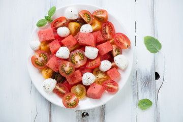 Salad with watermelon, tomatoes and mozzarella, above view
