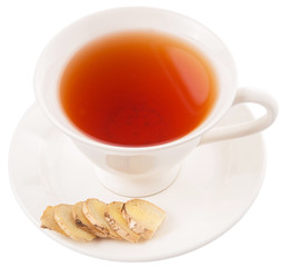 Ginger slices and a cup of tea over white background