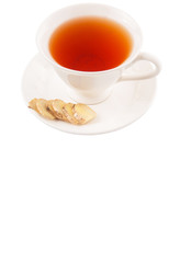 Ginger slices and a cup of tea over white background