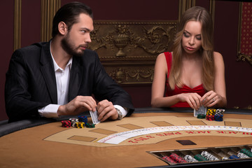 Fototapeta premium Handsome man and beautiful woman in casino