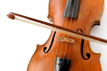 Old violin with a bow on a white background