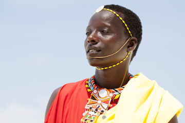 Young massai warrior man posing on bright sunny beach in Kenya