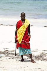 Young massai warrior man posing on bright sunny beach in Kenya