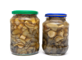 marinated mushrooms in the glass jars isolated on white backgrou