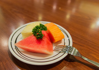 sliced pieces of watermelon, papaya and pineapple